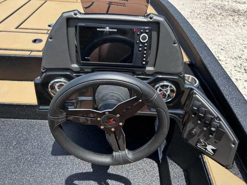 Slide: The Image of 2025 Xpress H20C Crappie boat dashboard with steering wheel and Humminbird fishfinder. - 11