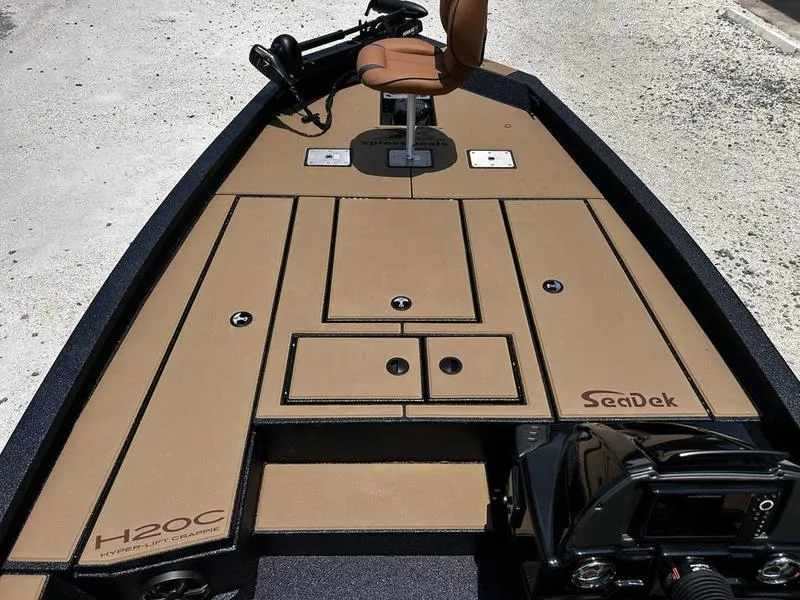 Slide: The Image of 2025 Xpress H20C Crappie boat with tan SeaDek flooring and fishing seat. - 12