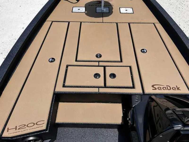 Slide: The Image of 2025 Xpress H20C Crappie boat deck with SeaDek flooring, featuring storage compartments. - 15