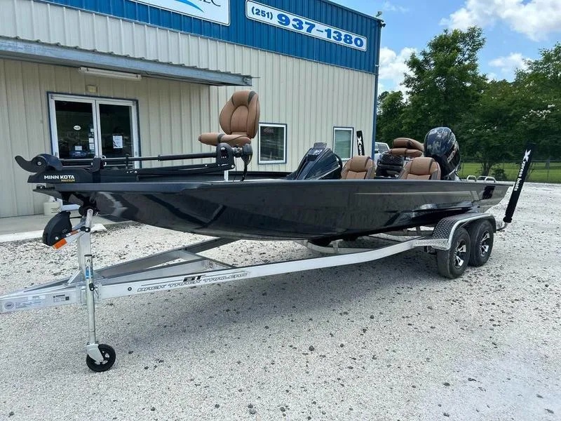 Slide: The Image of 2025 Xpress H20C Crappie boat on trailer, parked outside a building. - 2