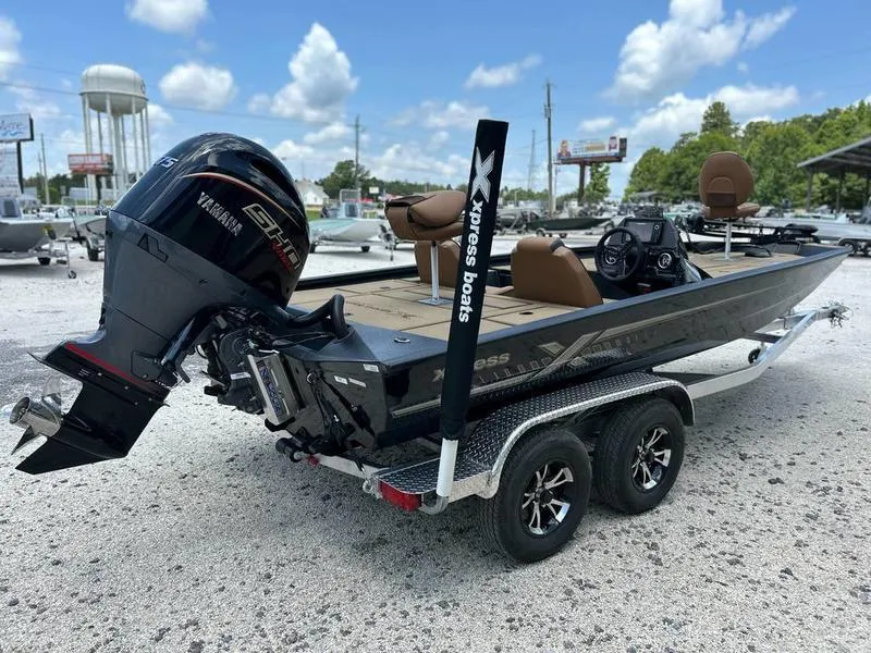 Slide: The Image of 2025 Xpress H20C Crappie boat on trailer with Yamaha engine, parked outdoors. - 3