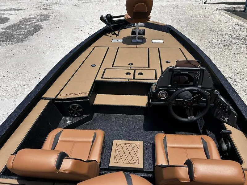 Slide: The Image of 2025 Xpress H20C Crappie boat interior with tan seating and modern dashboard. - 6