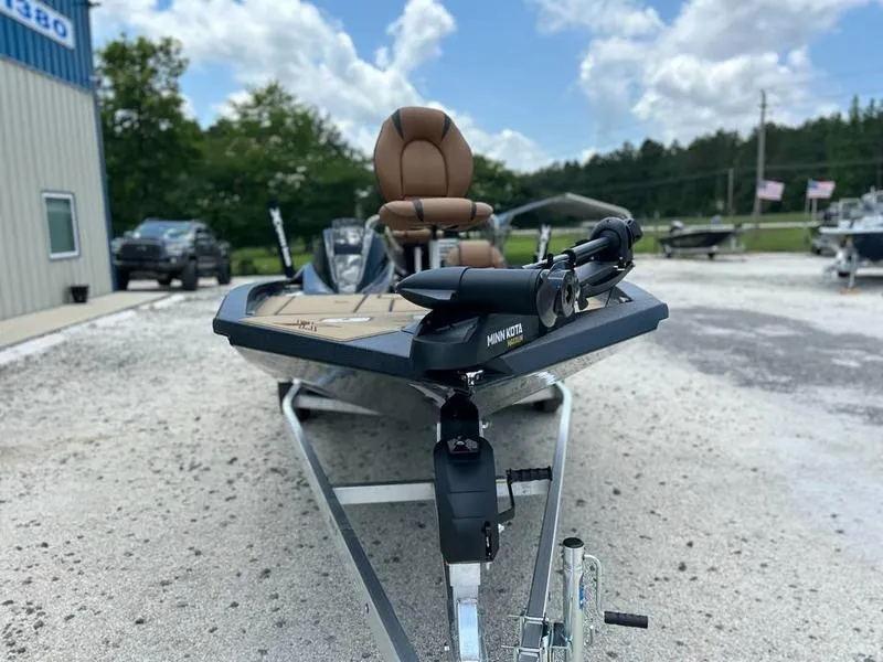 Slide: The Image of 2025 Xpress H20C Crappie boat with Minn Kota motor on gravel lot. - 9