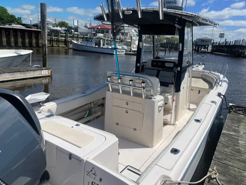 Slide: The Image of 2008 Grady-White 257 Advance CC boat docked at marina under blue sky. - 2