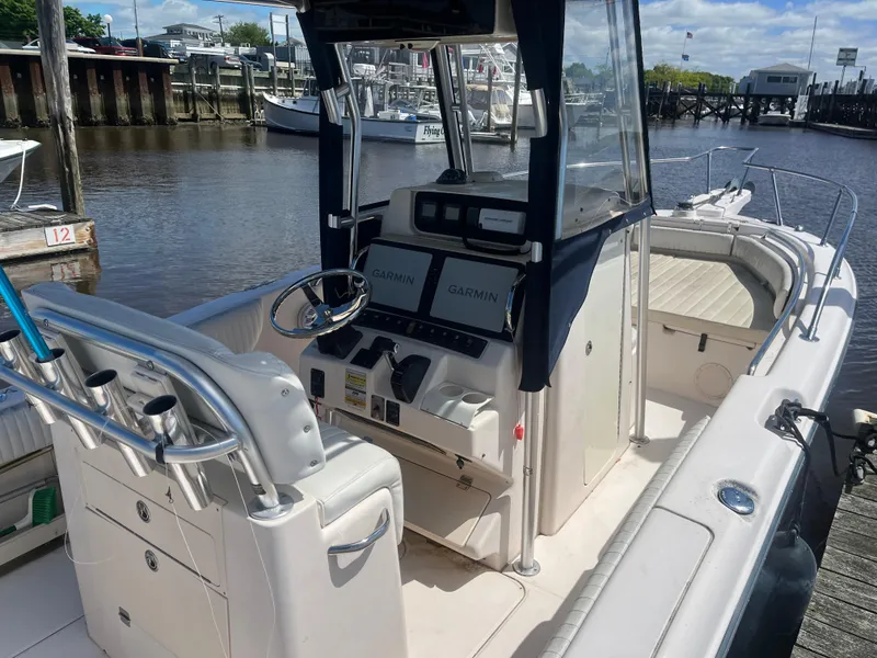 Slide: The Image of 2008 Grady-White 257 Advance CC boat with Garmin navigation, docked by a marina. - 3