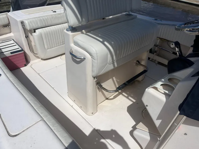 Slide: The Image of 2008 Grady-White 257 Advance CC boat interior with white seating and storage compartments. - 4