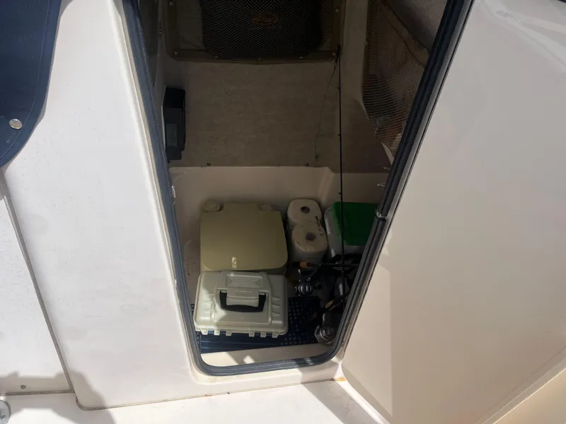 Slide: The Image of Storage compartment on a 2008 Grady-White 257 Advance CC boat with supplies. - 5
