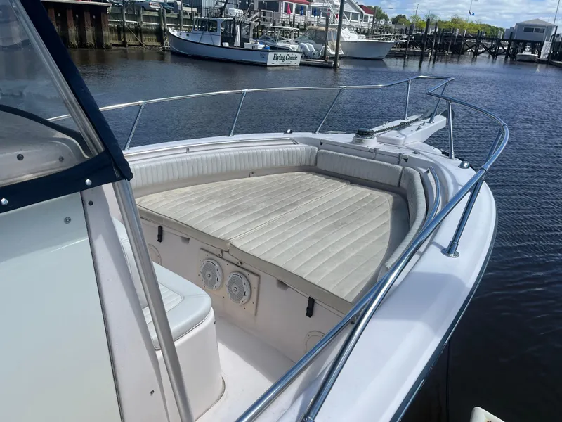 Slide: The Image of 2008 Grady-White 257 Advance CC boat docked at marina, featuring spacious seating area. - 6