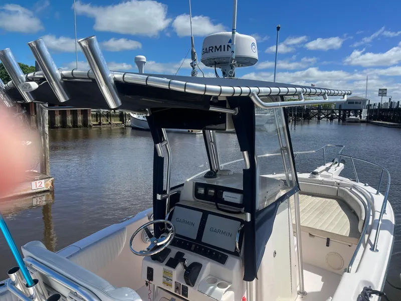 Slide: The Image of 2008 Grady-White 257 Advance CC boat with Garmin electronics, docked by a calm river. - 8