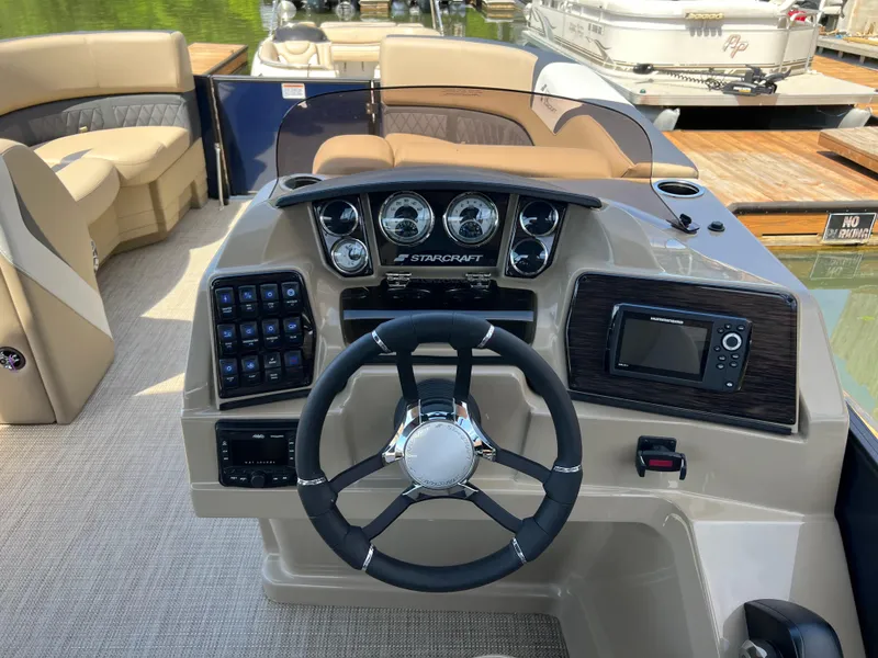 Slide: The Image of 2025 Starcraft SLS 3 Q DH boat dashboard with steering wheel and control panel. - 10