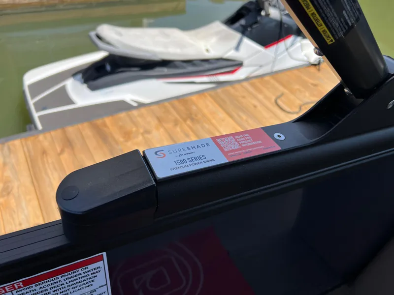 Slide: The Image of 2025 Starcraft SLS 3 Q DH boat with SureShade system, docked on wooden pier. - 15