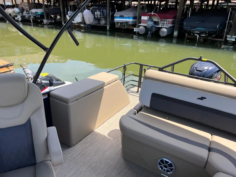 Slide: The Image of 2025 Starcraft SLS 3 Q DH pontoon boat interior at marina dock. - 17
