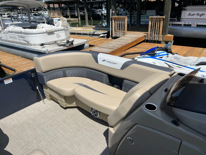Slide: The Image of 2025 Starcraft SLS 3 Q DH pontoon boat with beige seating at a dock. - 5