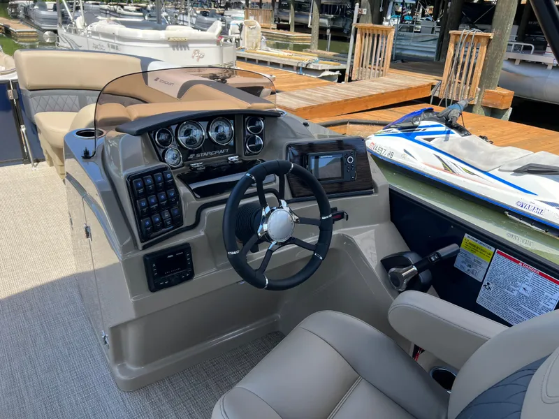 Slide: The Image of 2025 Starcraft SLS 3 Q DH boat dashboard with steering wheel and control panel. - 9
