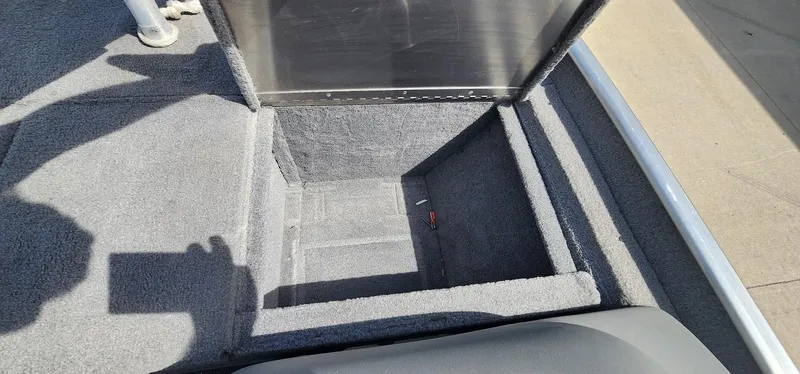 Slide: The Image of 2008 Tracker Pro Team 170 TX boat storage compartment, open and empty, with carpeted interior. - 10