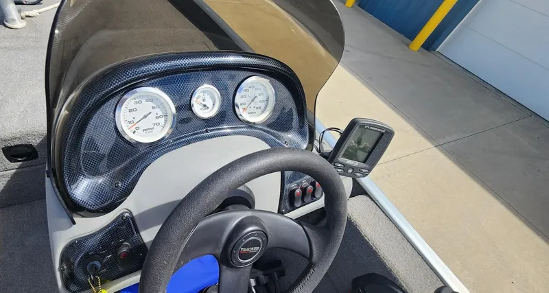 Slide: The Image of 2008 Tracker Pro Team 170 TX boat dashboard with steering wheel and gauges. - 14