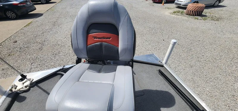 Slide: The Image of 2008 Tracker Pro Team 170 TX boat seat, gray and red, on gravel lot. - 16