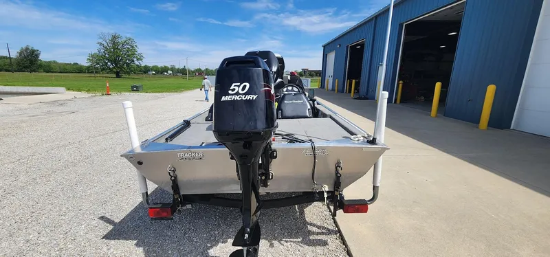 Slide: The Image of 2008 Tracker Pro Team 170 TX boat with Mercury 50 engine, parked outside a blue building. - 3
