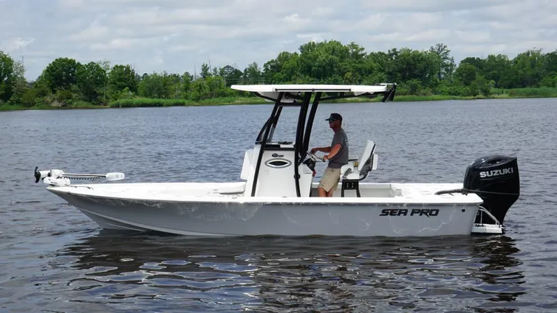 Slide: The Image of 2024 Sea Pro 230 Bay boat on water, featuring Suzuki outboard motor. - 0