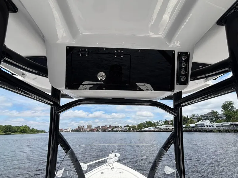 Slide: The Image of 2024 Sea Pro 230 Bay boat interior view with water and shoreline in the background. - 12