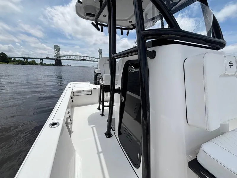Slide: The Image of 2024 Sea Pro 230 Bay boat on water, bridge in background, sunny day. - 13