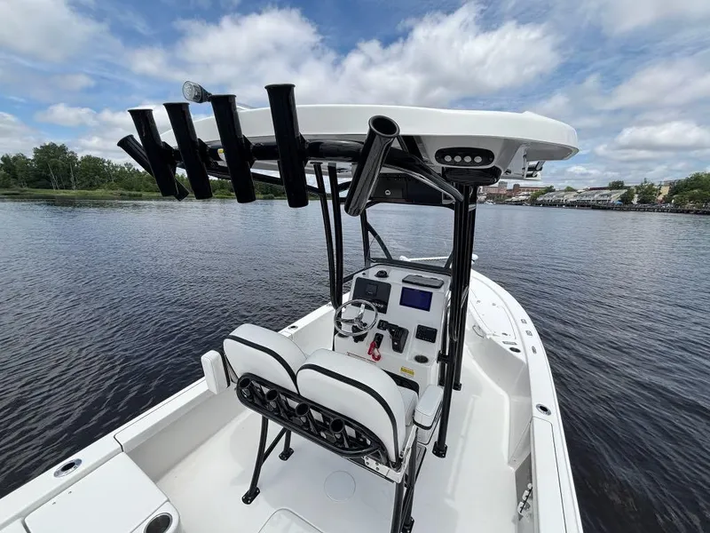 Slide: The Image of 2024 Sea Pro 230 Bay boat on calm water, featuring a sleek design and modern console. - 15