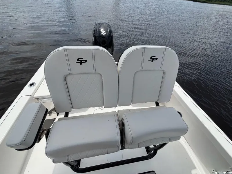 Slide: The Image of 2024 Sea Pro 230 Bay boat seats with logo, on calm water. - 17