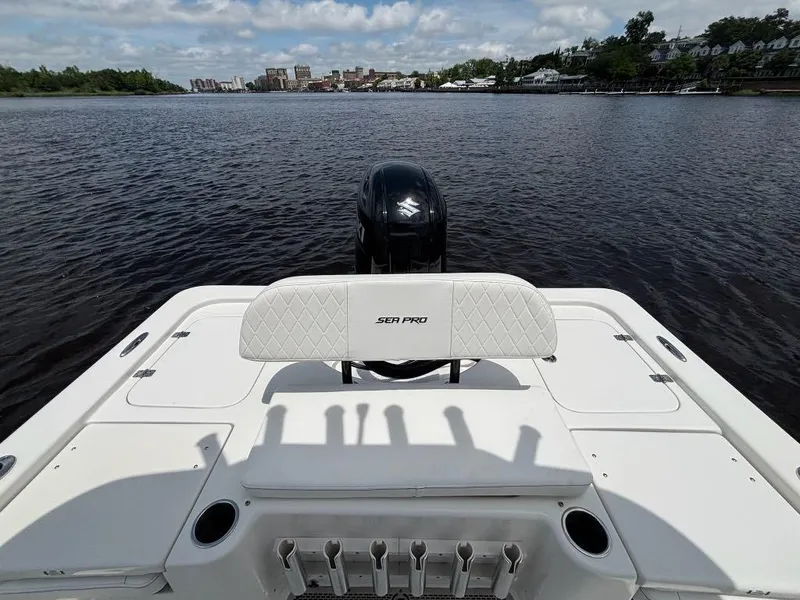 Slide: The Image of 2024 Sea Pro 230 Bay boat on calm water, featuring a sleek design and powerful engine. - 21