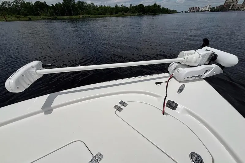 Slide: The Image of 2024 Sea Pro 230 Bay boat with Minn Kota trolling motor on calm water. - 23