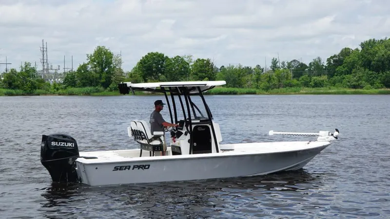 Slide: The Image of 2024 Sea Pro 230 Bay boat on water, featuring Suzuki outboard motor. - 4