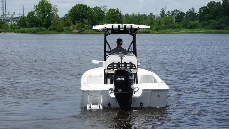 Slide: The Image of 2024 Sea Pro 230 Bay boat on a calm lake, rear view with outboard motor. - 6