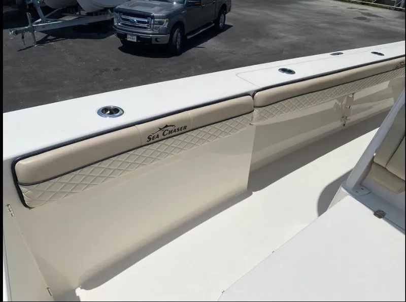 Slide: The Image of 2020 Sea Chaser 35 HFC CC boat interior with beige seating and logo. - 12