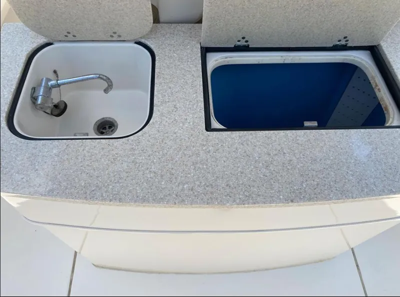 Slide: The Image of 2020 Sea Chaser 35 HFC CC boat sink and storage compartment on deck. - 14