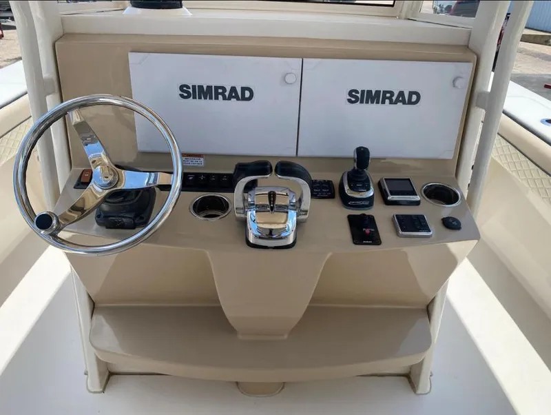 Slide: The Image of 2020 Sea Chaser 35 HFC CC boat dashboard with Simrad electronics and steering wheel. - 17