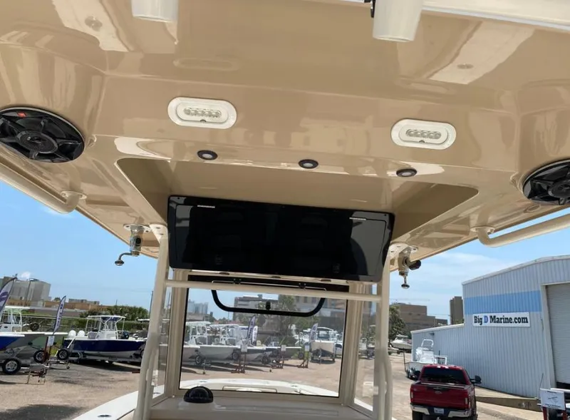 Slide: The Image of 2020 Sea Chaser 35 HFC CC boat interior with speakers and lights, docked at a marina. - 19
