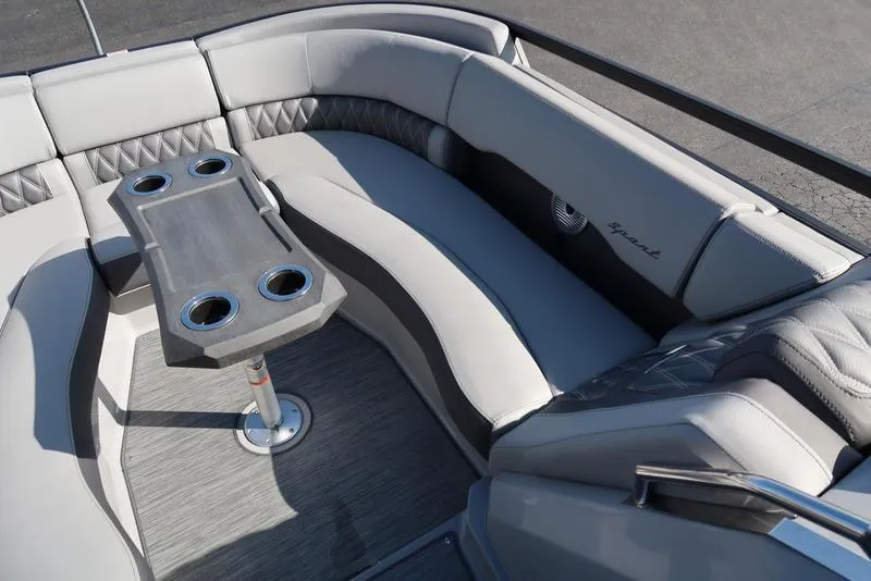 Slide: The Image of 2021 Bennington 24 RTFB boat interior with gray seating and cupholders. - 13