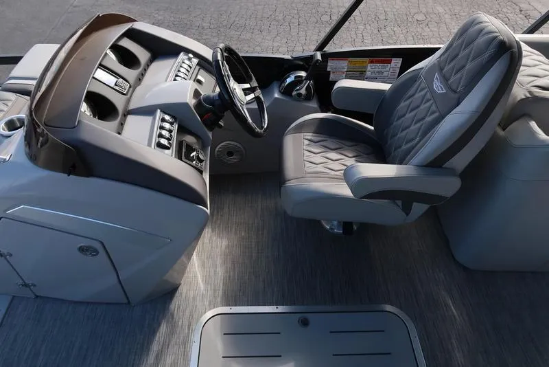 Slide: The Image of Captain's seat and helm of 2021 Bennington 24 RTFB pontoon boat, featuring modern controls. - 21