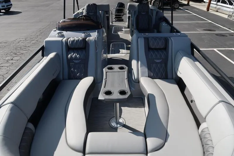 Slide: The Image of 2021 Bennington 24 RTFB pontoon boat interior with luxurious seating and table setup. - 30