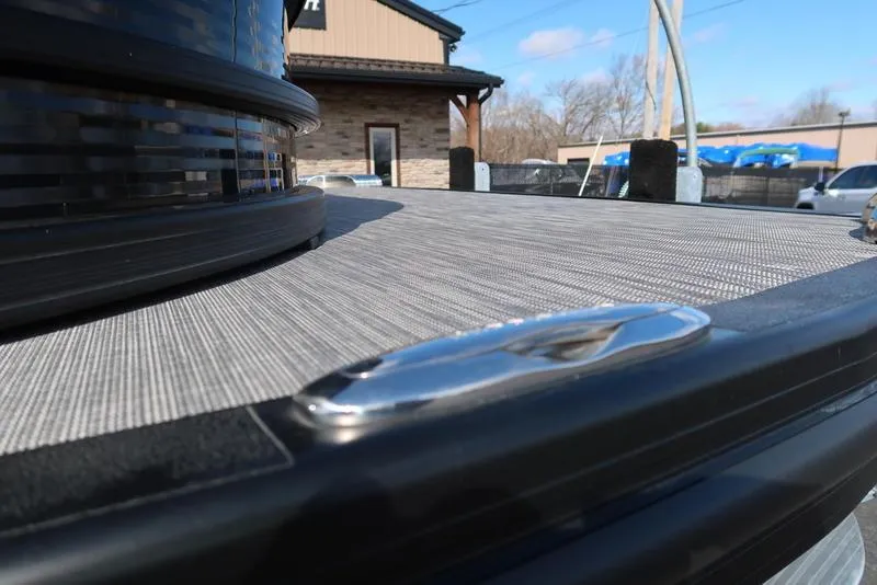 Slide: The Image of 2021 Bennington 24 RTFB boat deck with sleek metal cleat, outdoor setting. - 41