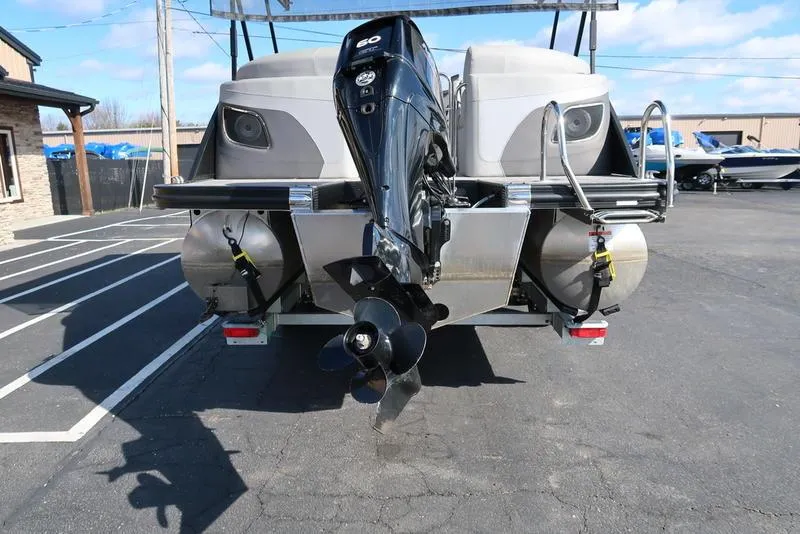 Slide: The Image of 2021 Bennington 24 RTFB pontoon boat rear view with outboard motor in parking lot. - 46