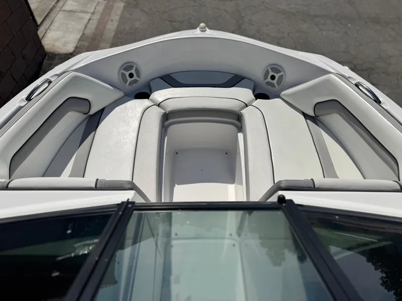 Slide: The Image of 2018 Yamaha Boats AR190 interior with white seating and speakers. - 11