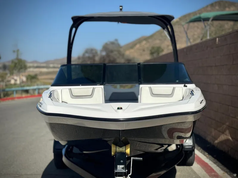 Slide: The Image of 2018 Yamaha AR190 boat on trailer, front view, parked outdoors. - 2