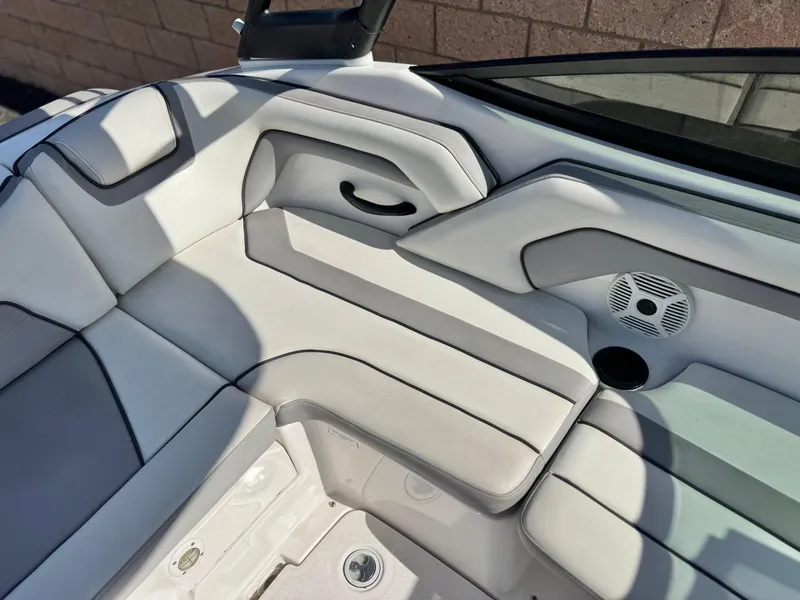 Slide: The Image of 2018 Yamaha AR190 boat interior with white cushioned seating and speaker. - 20