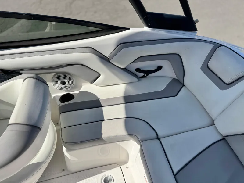 Slide: The Image of 2018 Yamaha AR190 boat interior with white cushioned seating and speaker. - 21