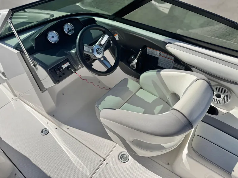 Slide: The Image of 2018 Yamaha Boats AR190 cockpit with steering wheel and gauges, featuring a comfortable captain's chair. - 22