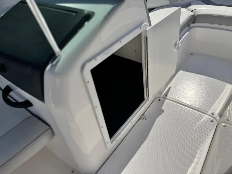 Slide: The Image of 2018 Yamaha AR190 boat interior storage compartment with open door. - 25