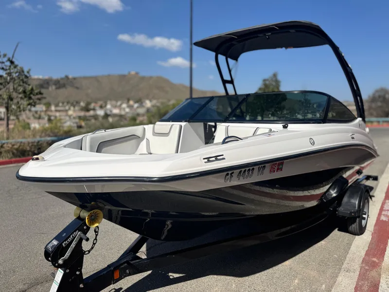 Slide: The Image of 2018 Yamaha AR190 boat on trailer, parked outdoors under clear blue sky. - 3