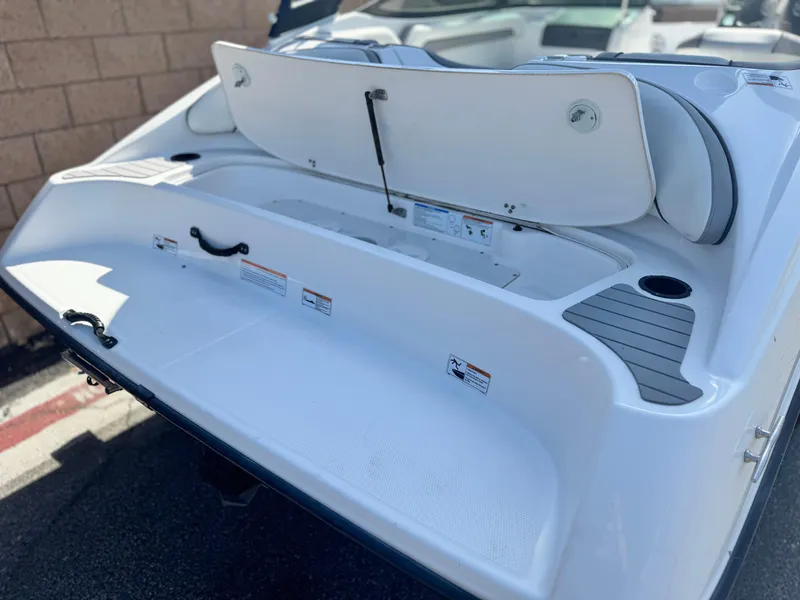 Slide: The Image of 2018 Yamaha AR190 boat rear deck with storage compartments and seating. - 7