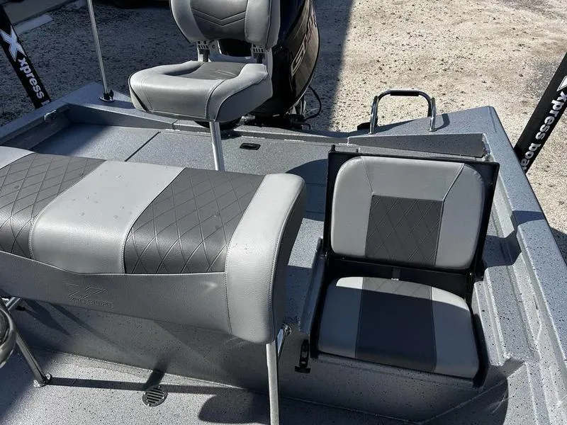 Slide: The Image of 2025 Xpress H20B boat interior with gray seating and diamond pattern upholstery. - 11