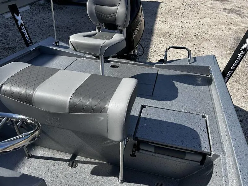 Slide: The Image of 2025 Xpress H20B boat interior with gray seating and storage compartments. - 12